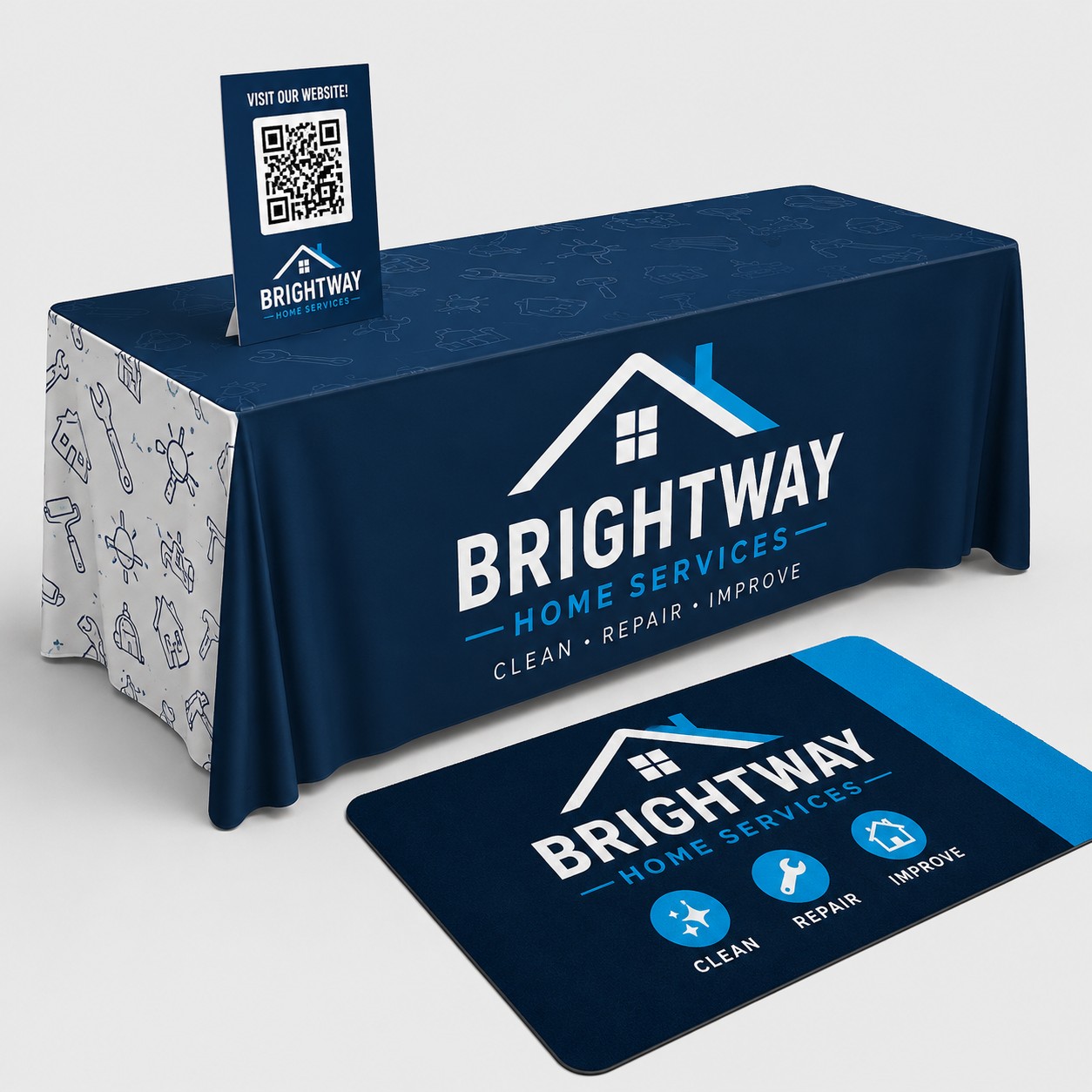 Custom tradeshow booth setup featuring a branded table cover, a floor graphic, and a rigid counter sign with a QR code.